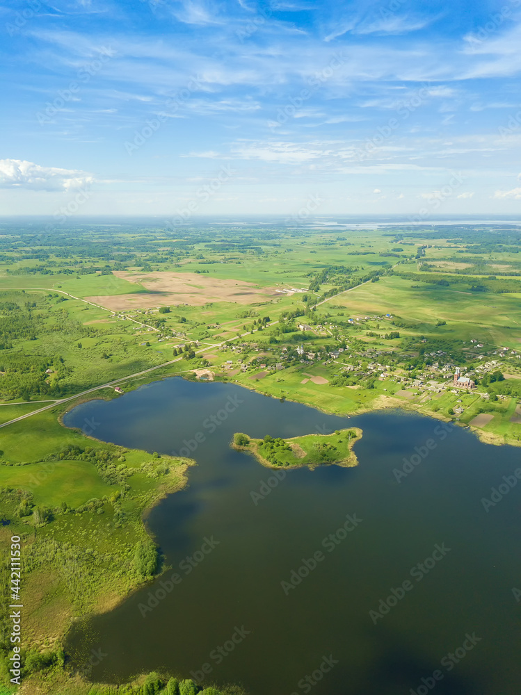 Beautiful landscape on the Braslav Lakes from a drone on a sunny day with a sky with clouds, Belarus. Vertical photo