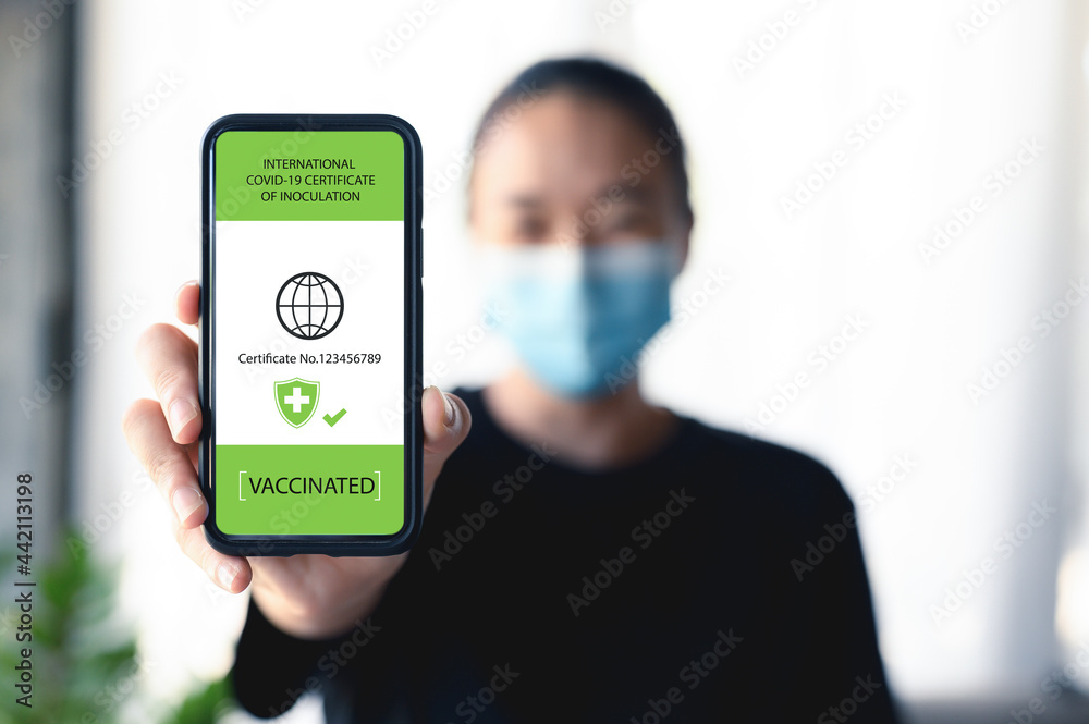 Vaccine passport, Close up hand of women with smartphone showing vaccination and health status proof that he has been immunized against COVID-19. Pandemic, new normal travel tourist concept. - obrazy, fototapety, plakaty 