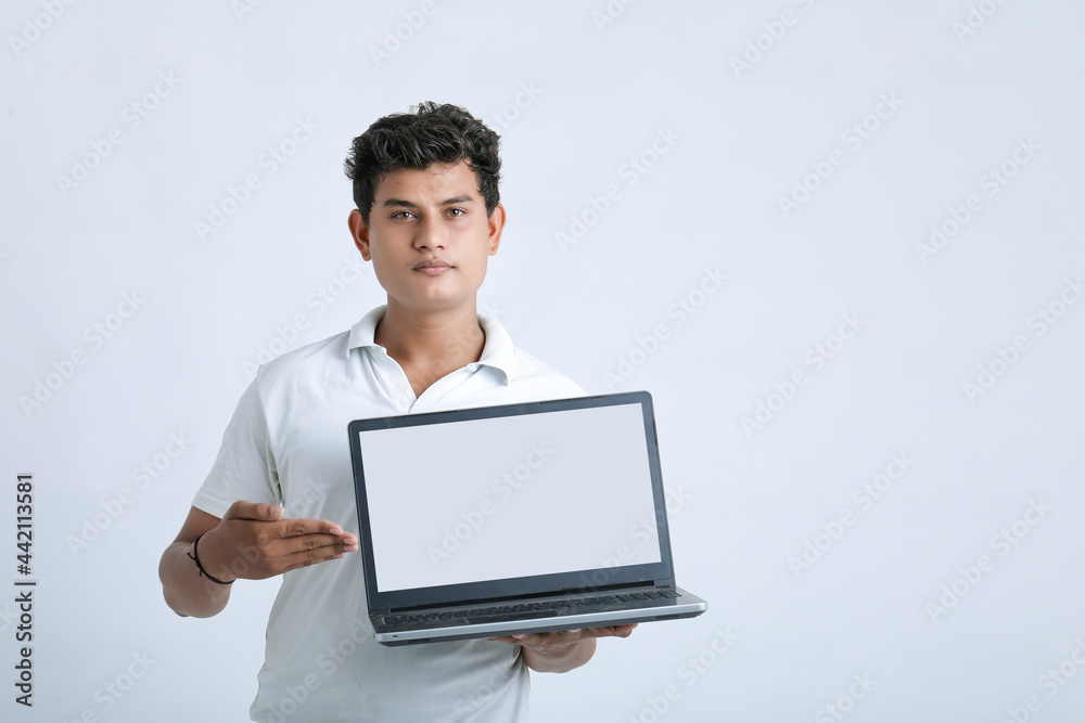 Young indian successful man showing laptop screen over white background. Young indian successful man showing laptop screen over white background.