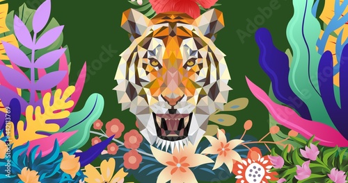 Composition of tiger s head with tropical leaves on green background