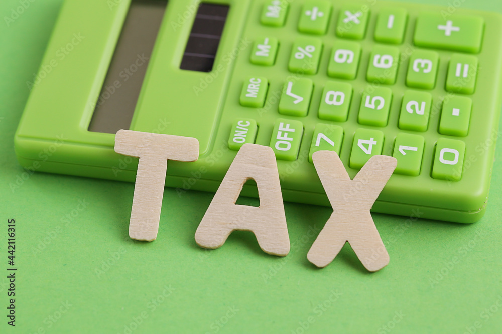 Renewable Energy Tax Credits. Green Calculator, word TAX written in