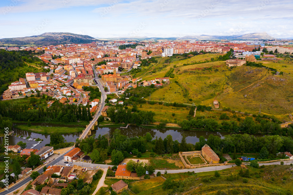Scenic view from drone of Soria cityscape on bank of Douro river in summer day, Spain
