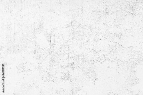 Old cement wall painted white, peeling paint texture and background