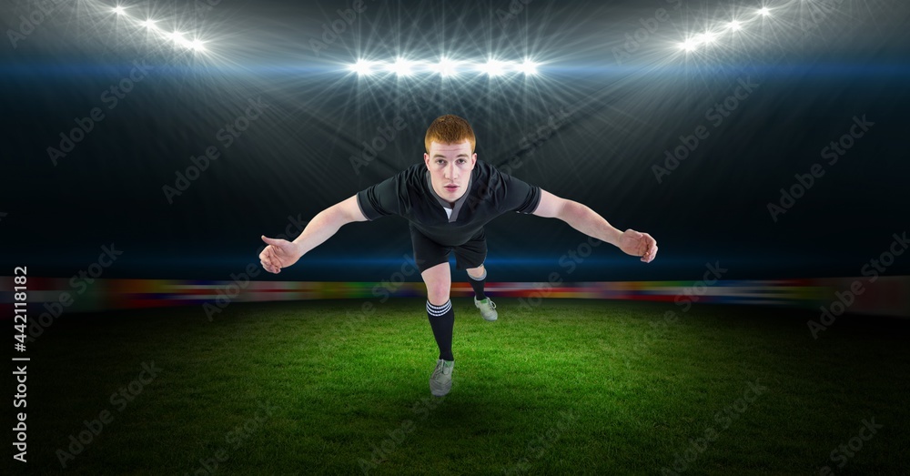 Composition of male rugby player jumping at rugby stadium Composition of male rugby player jumping at rugby stadium