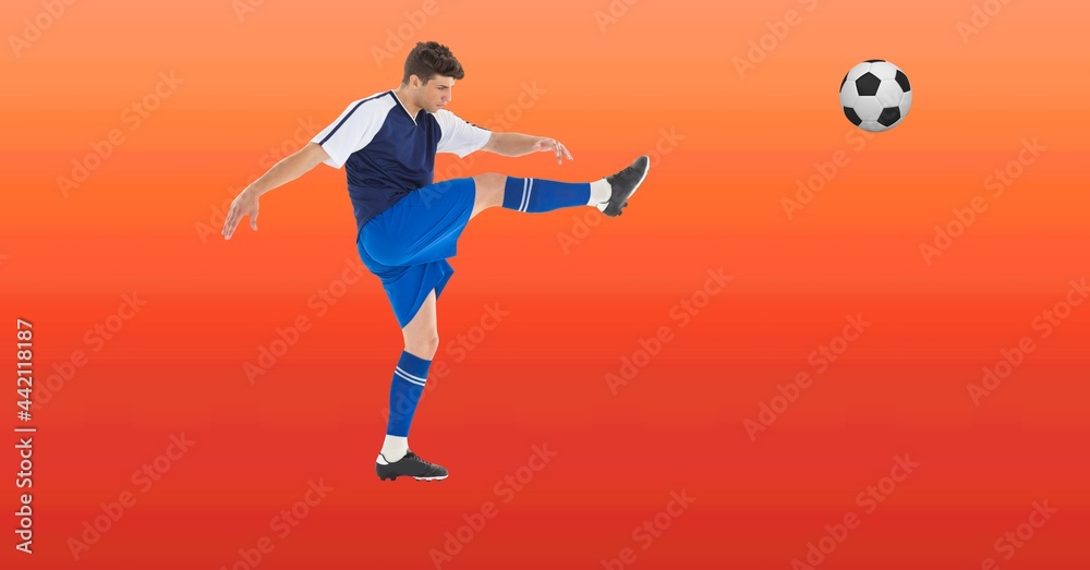 Composition of male football player kicking ball with copy space Composition of male football player kicking ball with copy space
