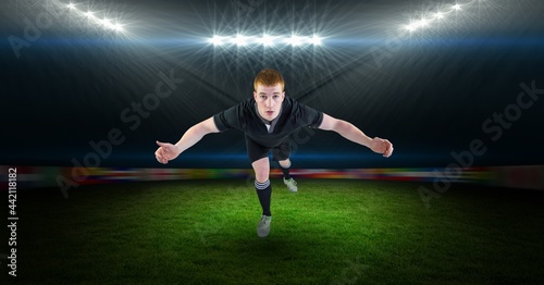 Composition of male rugby player jumping at rugby stadium