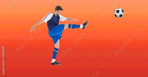 Composition of male football player kicking ball with copy space