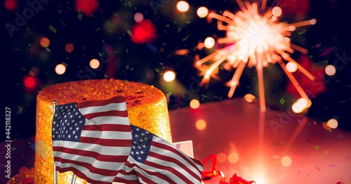 Composition of lit sparkler with american flags