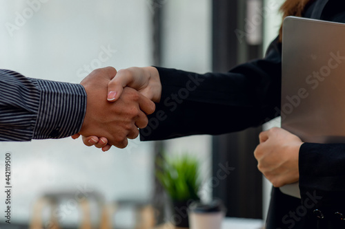  Close up of Businessman and woman shake hands as hello in office,Friend welcome, introduction, greet or thanks gesture, product advertisement, partnership approval, arm, strike a bargain on deal conc