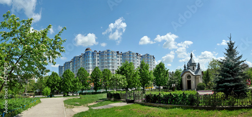 Panorama of a new residential area with modern houses, and christian chapel in the foreground of the city Ivano-Frankivsk in Ukraine. Spring