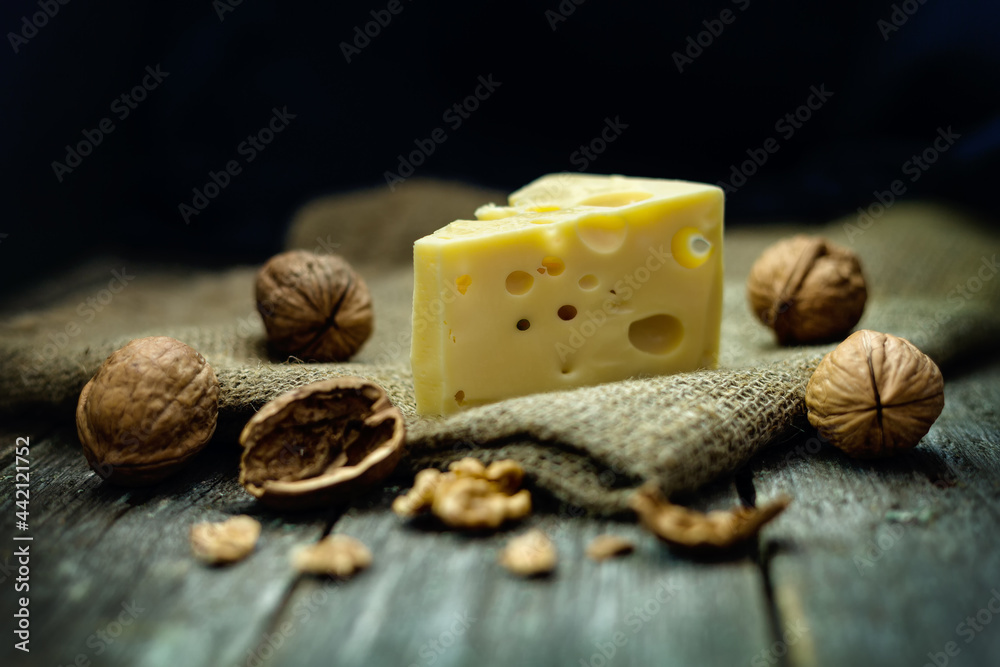 Cheese with walnuts on burlap in rustic style