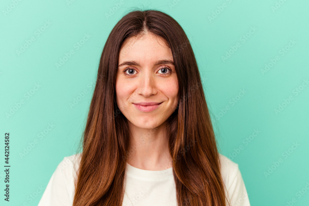 Fototapeta premium Young caucasian woman isolated on blue background