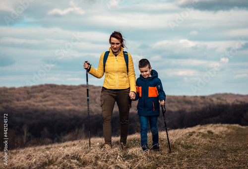 Mother and son hiking together in the mountains.