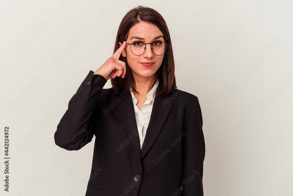 Young business woman isolated on white background pointing temple with finger, thinking, focused on a task.