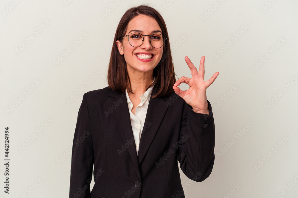 Young business woman isolated on white background cheerful and confident showing ok gesture. Young business woman isolated on white background cheerful and confident showing ok gesture.