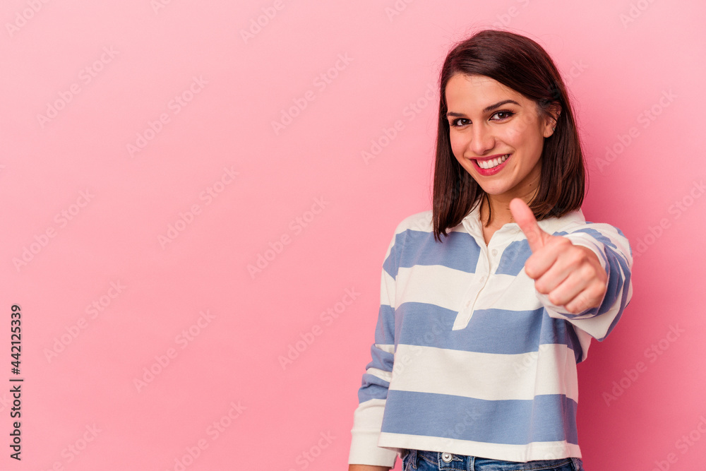 Young caucasian woman isolated on pink background smiling and raising thumb up Young caucasian woman isolated on pink background smiling and raising thumb up