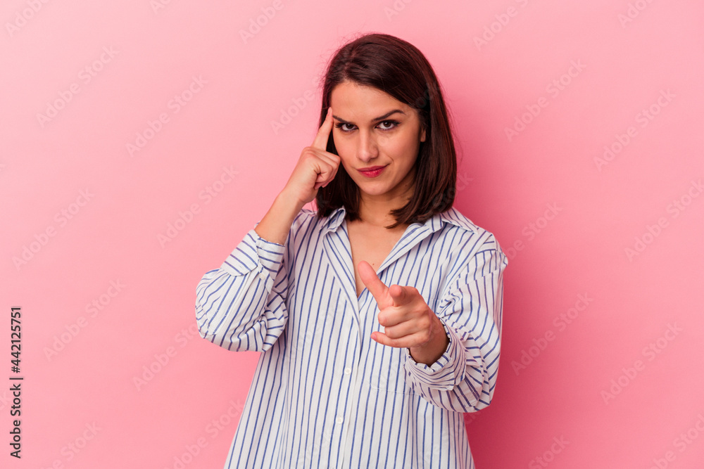 Young caucasian woman isolated on pink background pointing temple with finger, thinking, focused on a task. Young caucasian woman isolated on pink background pointing temple with finger, thinking, focused on a task.