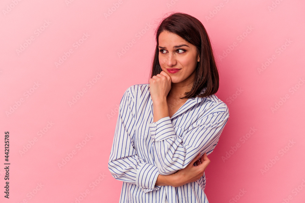 Young caucasian woman isolated on pink background confused, feels doubtful and unsure. Young caucasian woman isolated on pink background confused, feels doubtful and unsure.