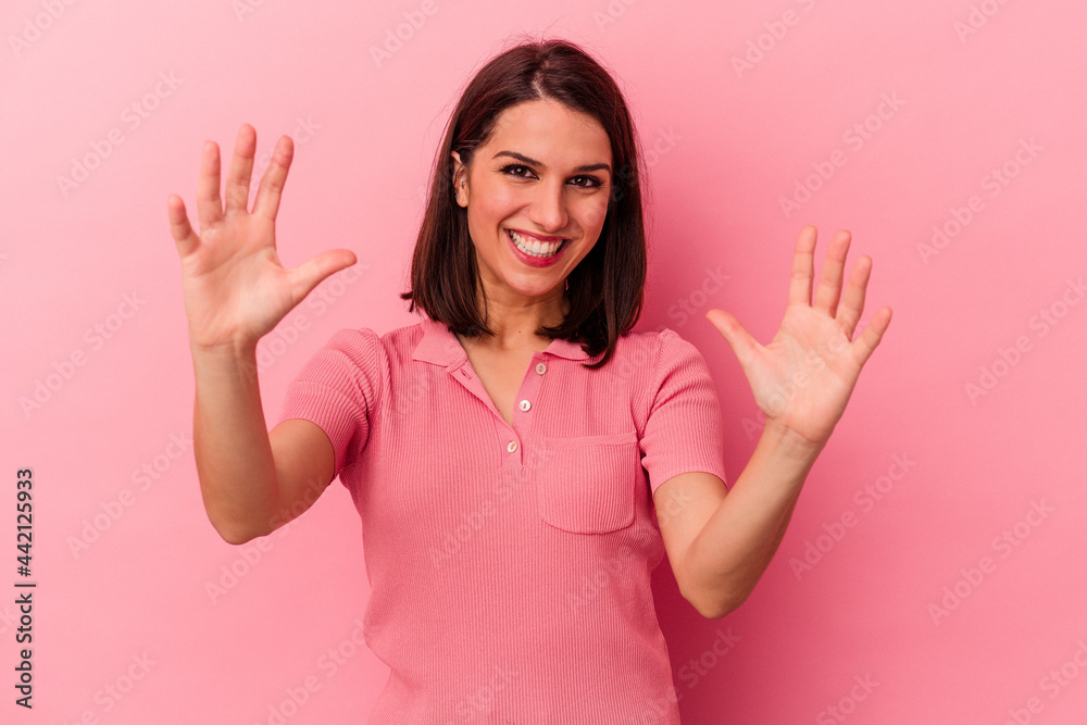 Young caucasian woman isolated on pink background celebrating a victory or success, he is surprised and shocked. Young caucasian woman isolated on pink background celebrating a victory or success, he is surprised and shocked.