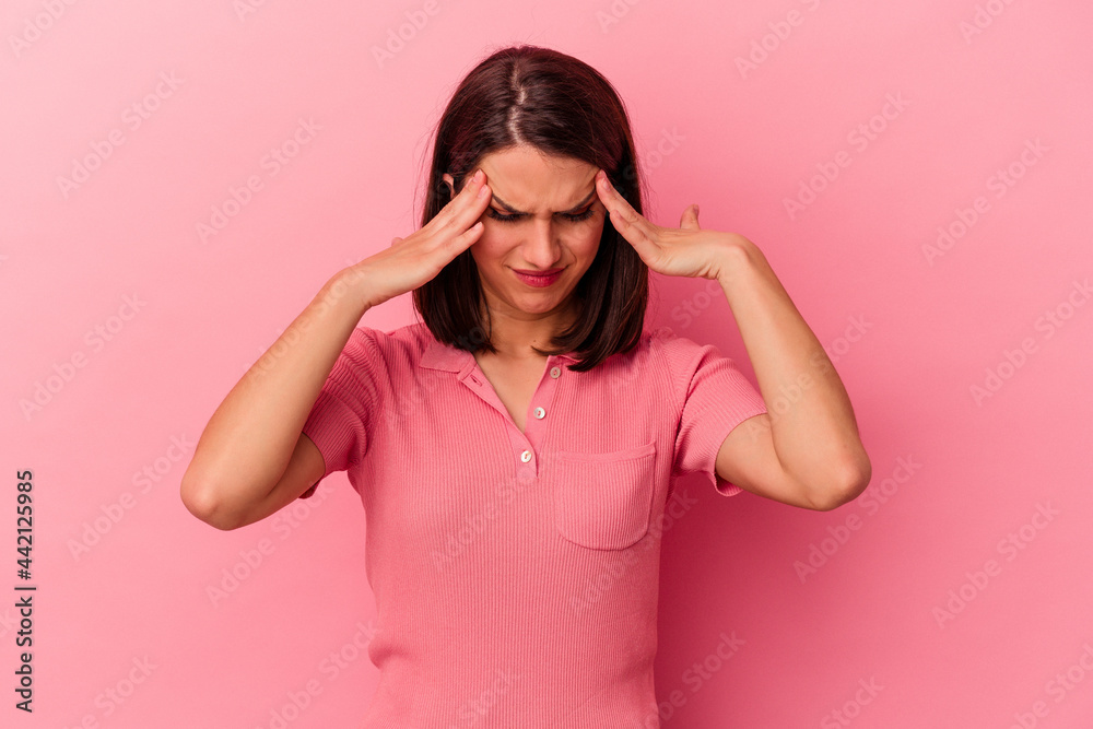 Young caucasian woman isolated on pink background having a head ache, touching front of the face. Young caucasian woman isolated on pink background having a head ache, touching front of the face.