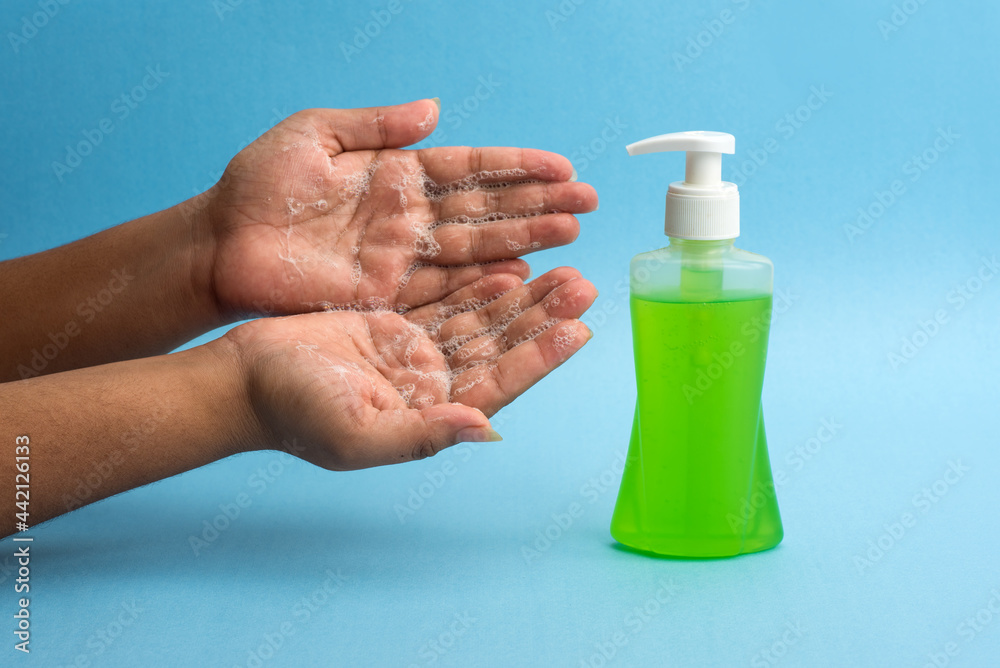 Closeup of person washing hands or using a sanitizing gel. Cleanliness and body care concept. Closeup of person washing hands or using a sanitizing gel. Cleanliness and body care concept.