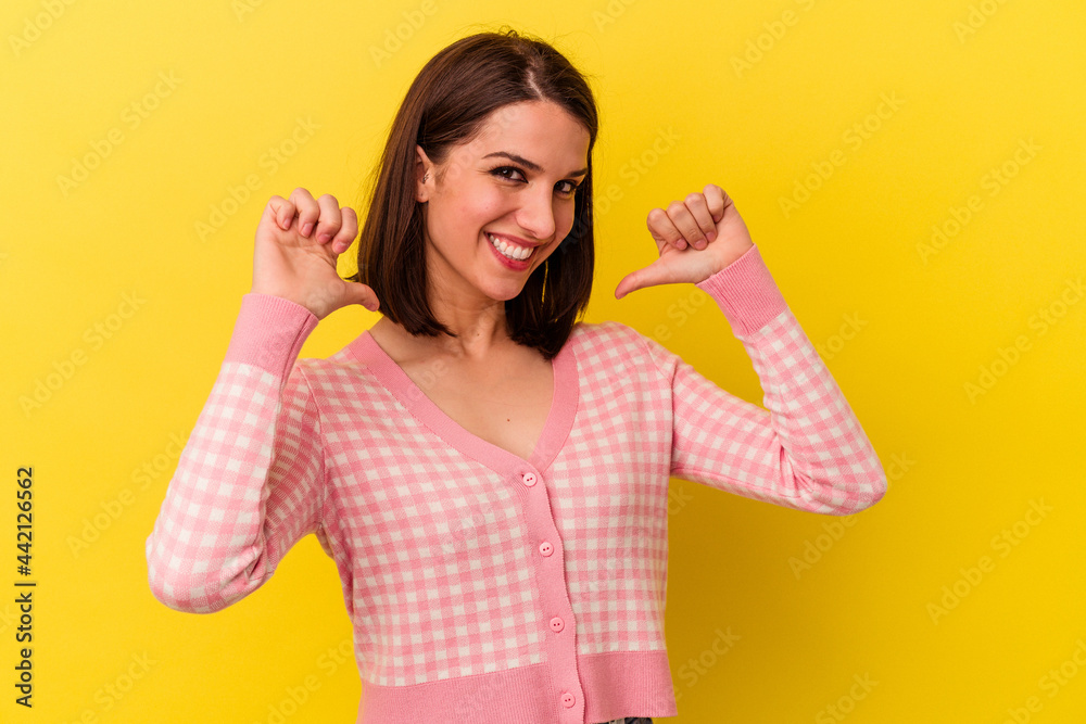 Young caucasian woman isolated on yellow background feels proud and self confident, example to follow. Young caucasian woman isolated on yellow background feels proud and self confident, example to follow.