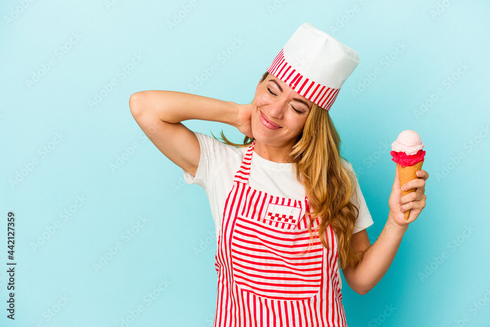 Caucasian ice cream maker woman holding an ice cream isolated on blue background touching back of head, thinking and making a choice. Caucasian ice cream maker woman holding an ice cream isolated on blue background touching back of head, thinking and making a choice.