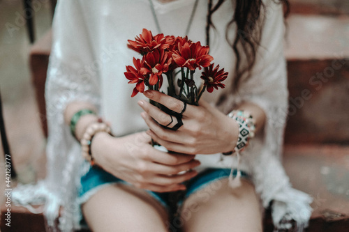 Принти на полотні Female hands holding a bouquet of fresh red flowers