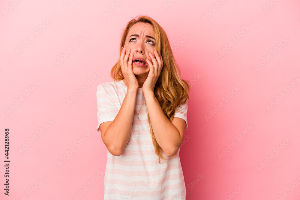 Caucasian blonde woman isolated on pink background whining and crying disconsolately. Caucasian blonde woman isolated on pink background whining and crying disconsolately.
