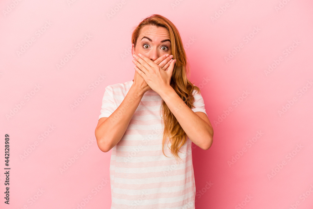 Caucasian blonde woman isolated on pink background shocked covering mouth with hands. Caucasian blonde woman isolated on pink background shocked covering mouth with hands.