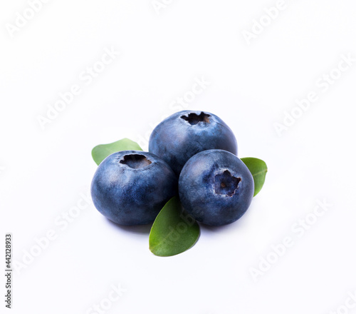 Blueberries with leaves, isolated on white background, close-up.