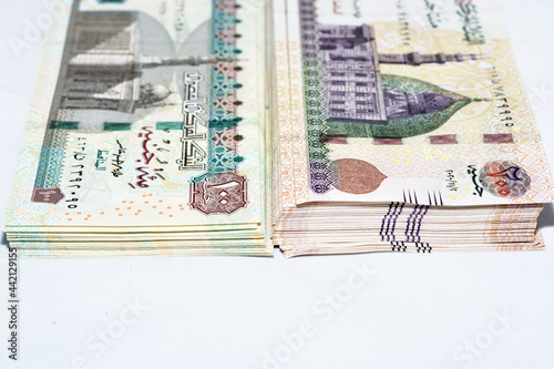 Stacks of obverse sides of 200 Egyptian pounds and 100 Egyptian pounds banknotes obverse side of 200 LE has an image of Mosque of Qani-Bay and 100 LE has image of Sultan Hassan Mosque in Cairo, Egypt. photo