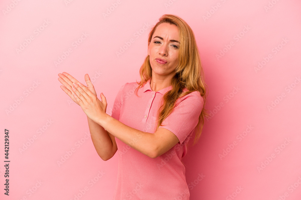 Caucasian blonde woman isolated on pink background feeling energetic and comfortable, rubbing hands confident. Caucasian blonde woman isolated on pink background feeling energetic and comfortable, rubbing hands confident.