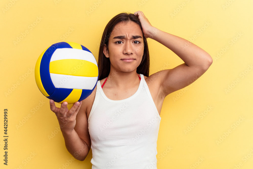 Young mixed race woman playing volleyball on the beach isolated on yellow background being shocked, she has remembered important meeting.