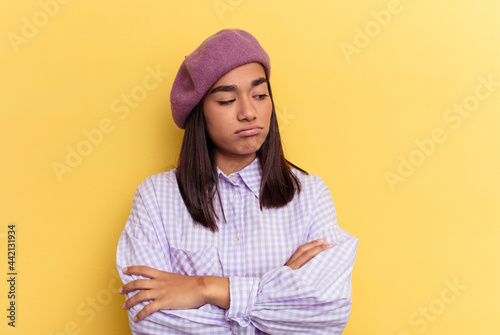 Young mixed race woman isolated on yellow background tired of a repetitive task. © Asier