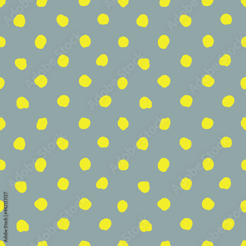 Illuminating dots on ultimate gray background. Abstract seamless pattern with yellow polka dot on gray.