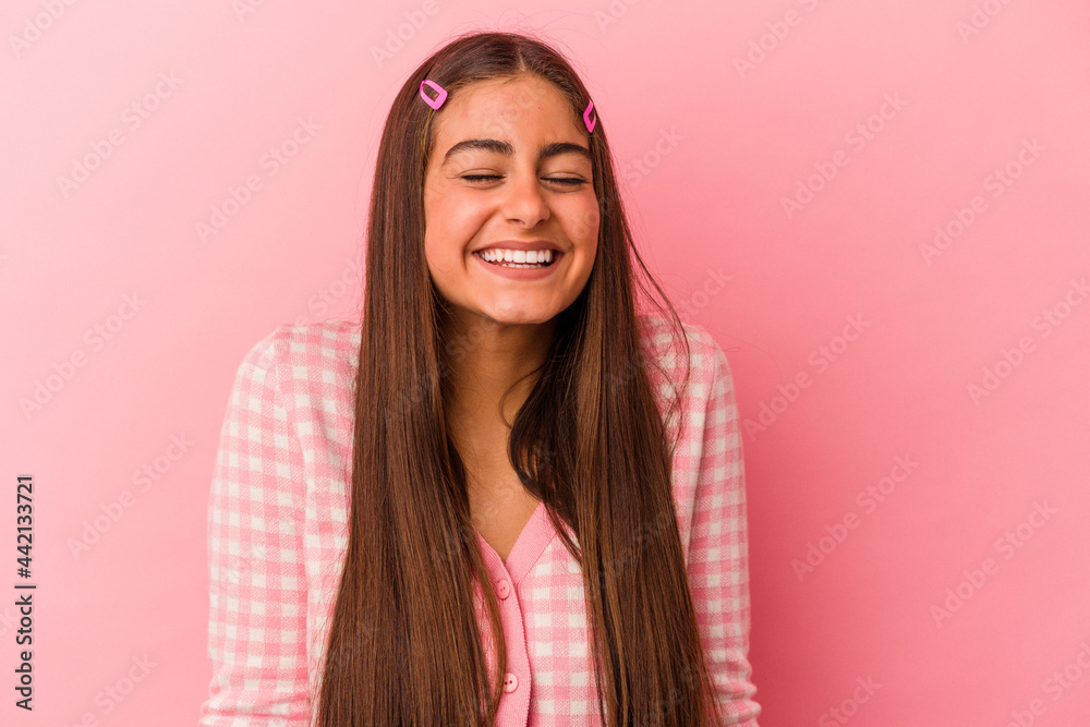 Young caucasian woman isolated on pink background laughs and closes eyes, feels relaxed and happy. Young caucasian woman isolated on pink background laughs and closes eyes, feels relaxed and happy.