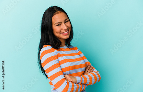 Young Venezuelan woman isolated on blue background happy, smiling and cheerful.