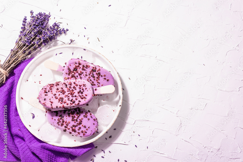 Purple Lavender flavored ice cream with flower bouquet, vintage silver spoon, ceramic stand Purple Lavender flavored ice cream with flower bouquet, vintage silver spoon, ceramic stand
