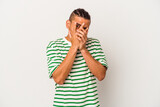 Young venezuelan man isolated on white background blink through fingers frightened and nervous.