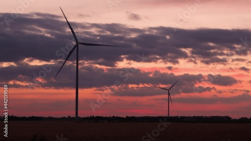 Two wind turbines on the background of the sunset sky