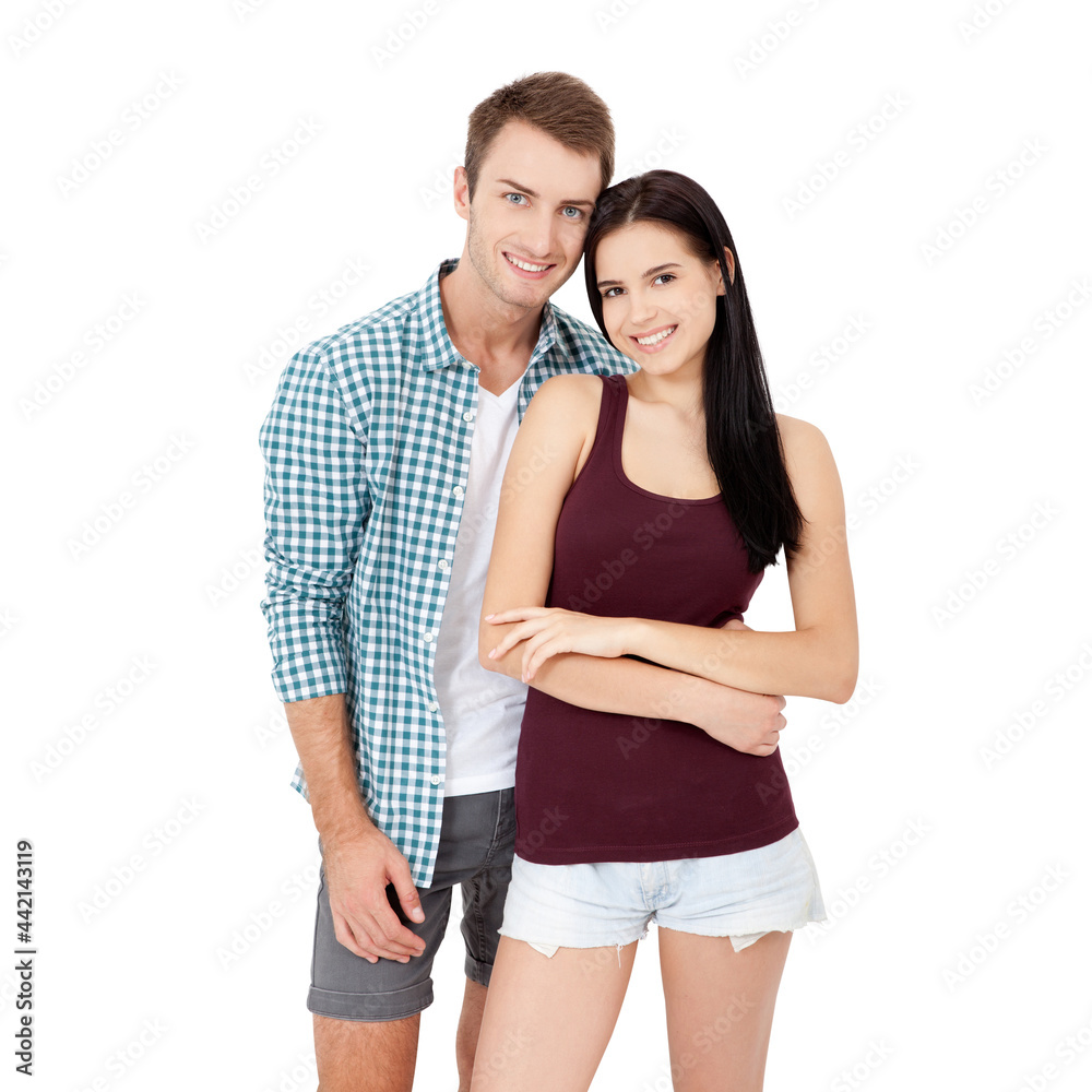 Happy young couple with white perfect smile in summer clothing embracing and looking camera on white background Happy young couple with white perfect smile in summer clothing embracing and looking camera on white background