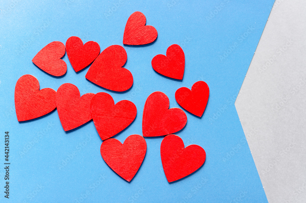 solid blue and blue striped paper background featuring a bunch of red hearts