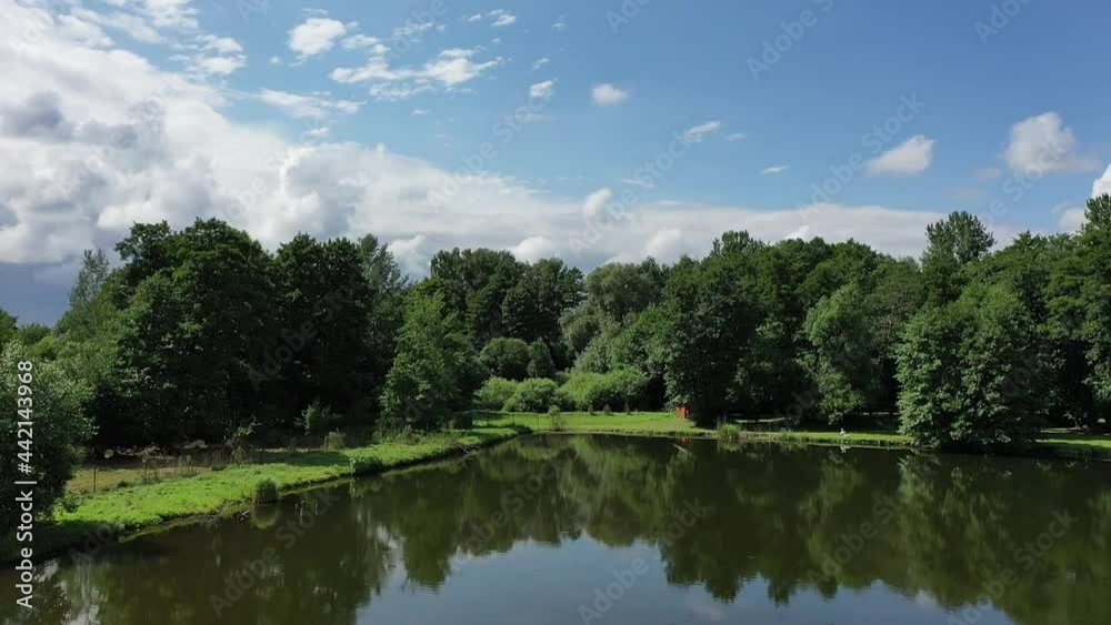 Summer natural landscape. Green trees, water, blue sky. Drone view Summer natural landscape. Green trees, water, blue sky. Drone view