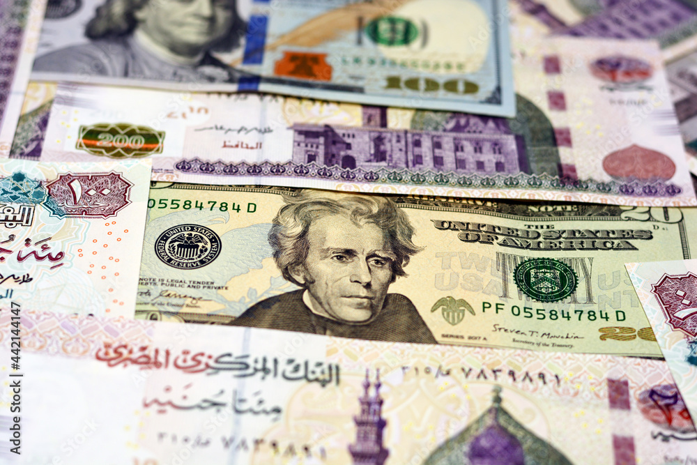 Egypt national currency with USA dollar banknote backdrop. Money