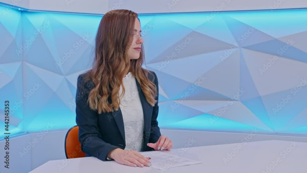 girl TV presenter looking at the camera and smiling . prores422