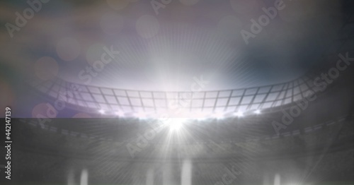 Composition of sports stadium with glowing spotlights and copy space