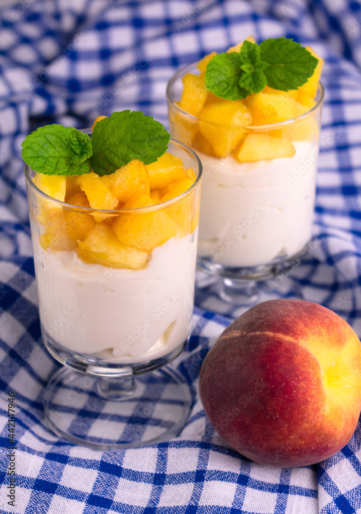 Yogurt with fresh peach and mint leaf.
View from above.