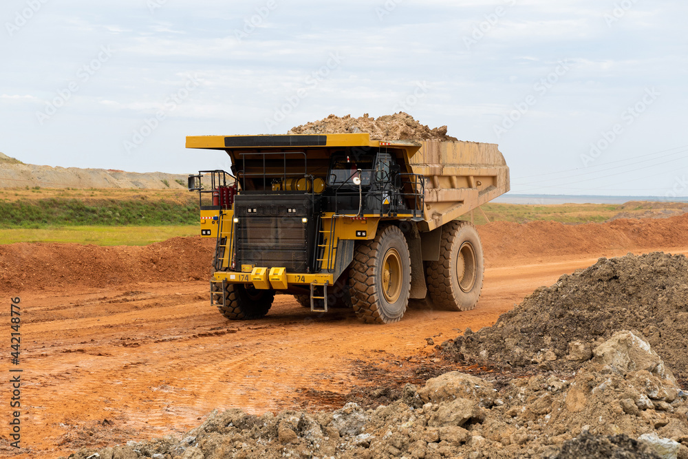 a mining dump truck drives and unloads bauxite minerals a mining dump truck drives and unloads bauxite minerals