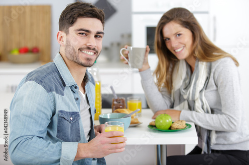 attractive couple having breakfast at home